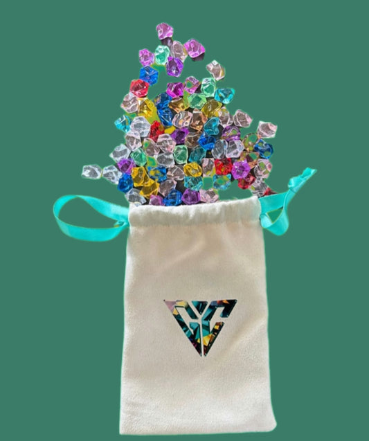 Colorful game tokens set in a drawstring pouch spilling out with various vibrant colors